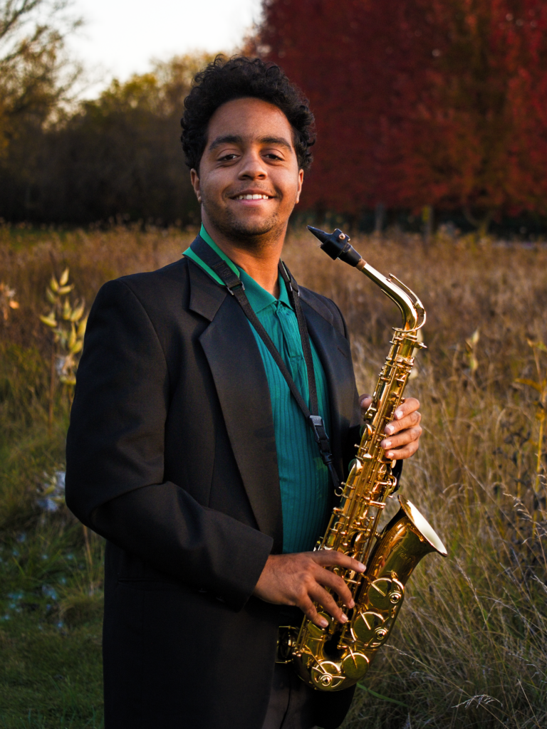 Picture of Nolan holding a Saxophone